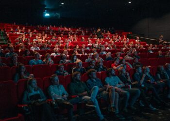 Moviegoers enjoying April 2025 new releases in theaters and on streaming platforms.