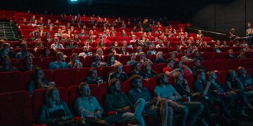 Moviegoers enjoying April 2025 new releases in theaters and on streaming platforms.